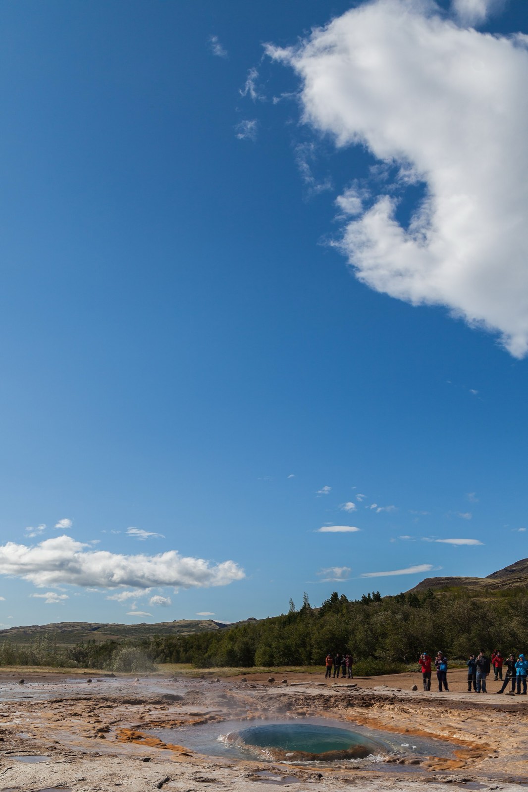 Strokkur erupting in the Geysir field — the geothermal force behind “Smoke Bay.”